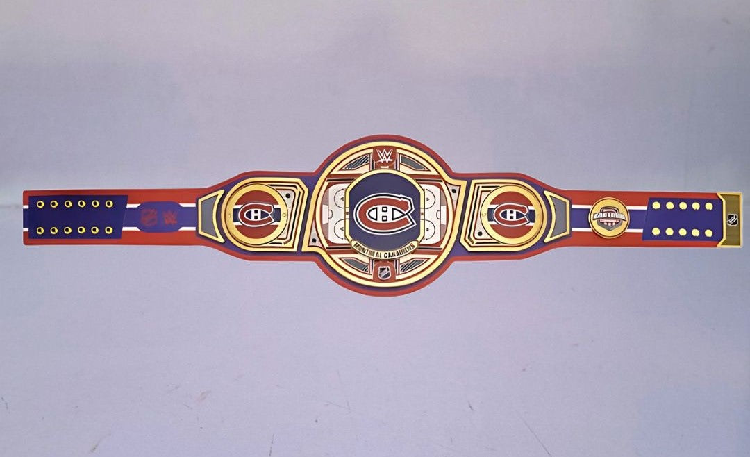Detailed view of the Montreal Canadiens WWE Championship Belt, featuring embossed logos and a polished finish.