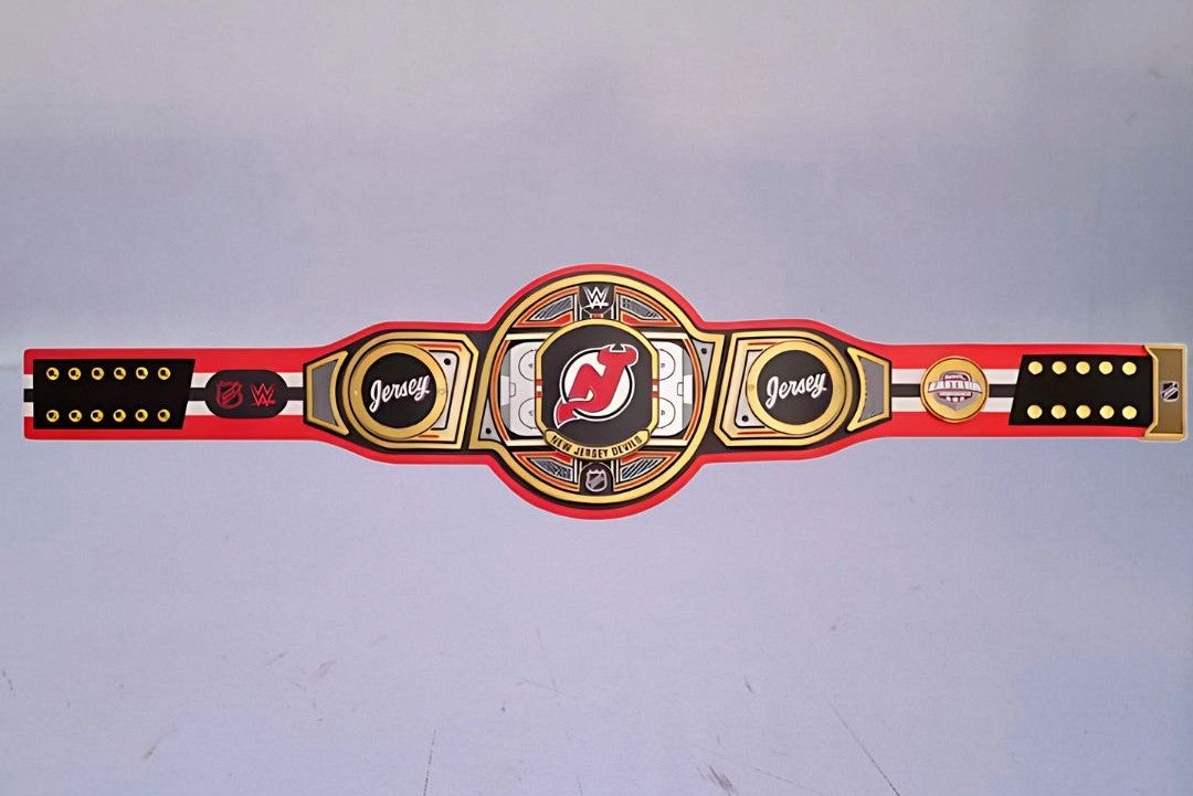 Detailed view of the New Jersey Devils WWE Championship Belt, featuring embossed logos and a polished finish.